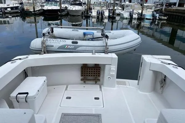 Slide: The Image of 2000 Mainship Pilot 34 Sedan boat with inflatable dinghy at marina. - 3