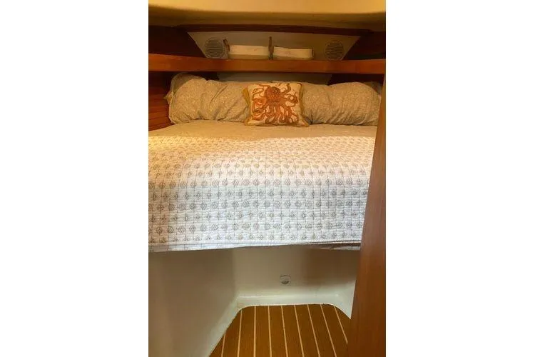 Slide: The Image of Cozy cabin interior of 2000 Mainship Pilot 34 Sedan with decorative bedding. - 8