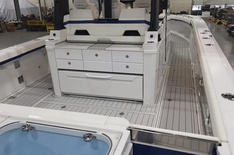 Slide: The Image of 2024 Formula 387 Center Console Fish boat interior with seating and storage compartments. - 13