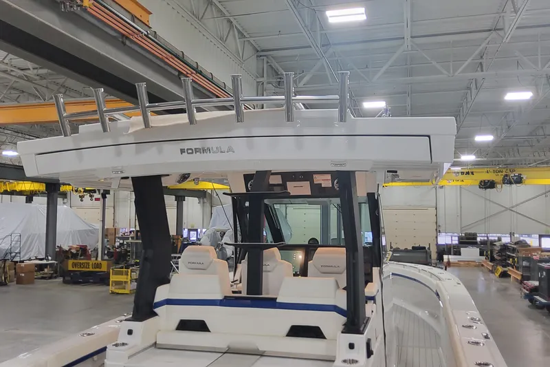 Slide: The Image of 2024 Formula 387 Center Console Fish boat in a spacious indoor facility. - 14