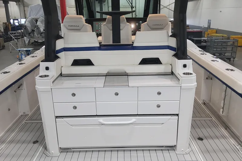 Slide: The Image of 2024 Formula 387 Center Console Fish boat interior with seating and storage compartments. - 18