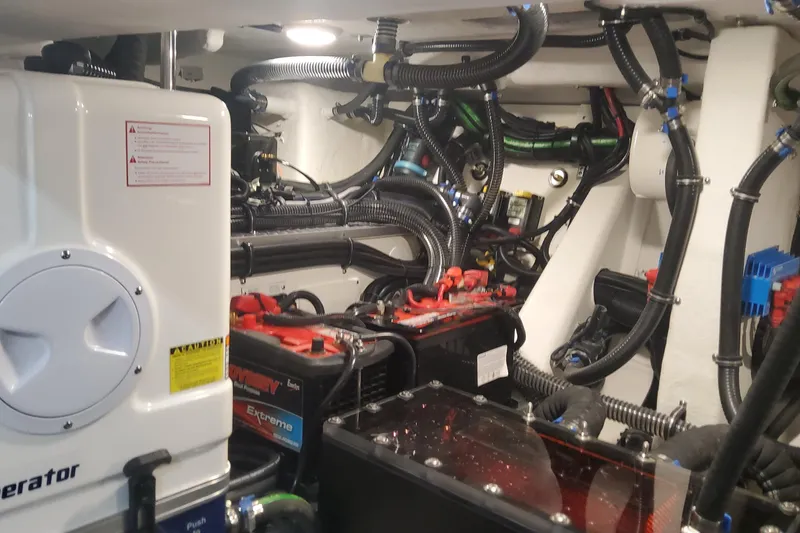 Slide: The Image of Engine room of 2024 Formula 387 Center Console Fish with complex wiring and equipment. - 25
