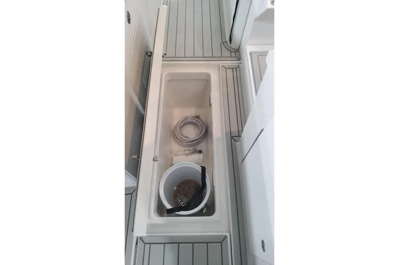 Slide: The Image of 2024 Formula 387 Center Console Fish storage compartment with bucket and rope. - 28