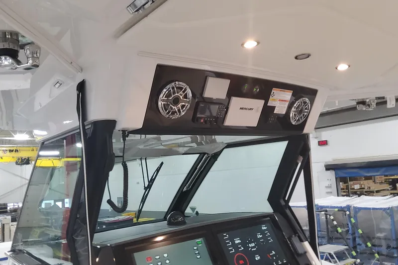 Slide: The Image of 2024 Formula 387 Center Console Fish boat dashboard with advanced controls and speakers. - 40