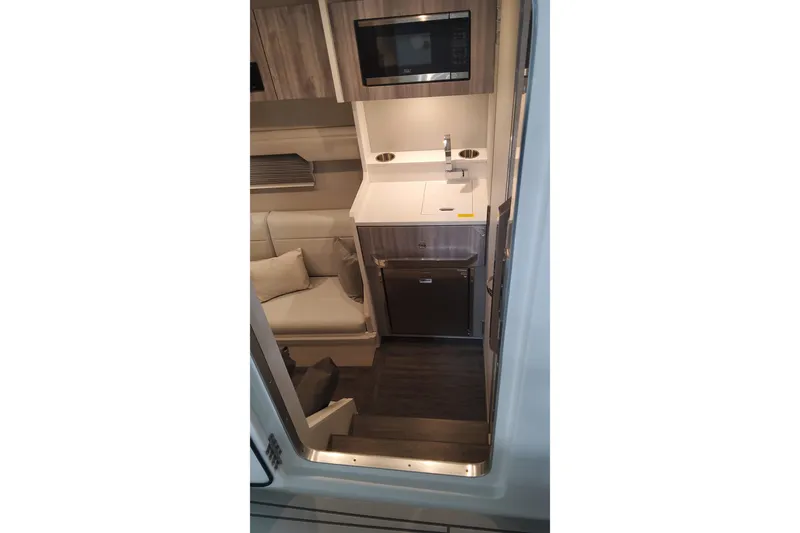 Slide: The Image of 2024 Formula 387 Center Console Fish interior with kitchenette and seating area. - 52