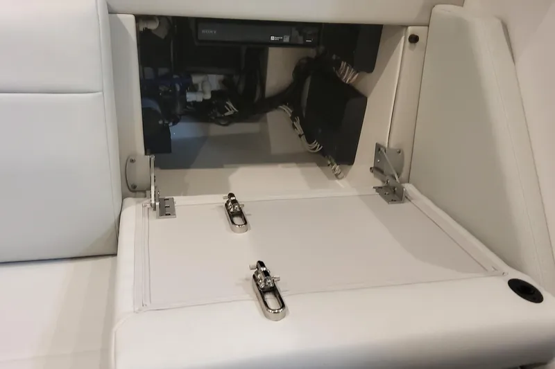 Slide: The Image of 2024 Formula 387 Center Console Fish boat interior storage compartment with white cushioned seating. - 57