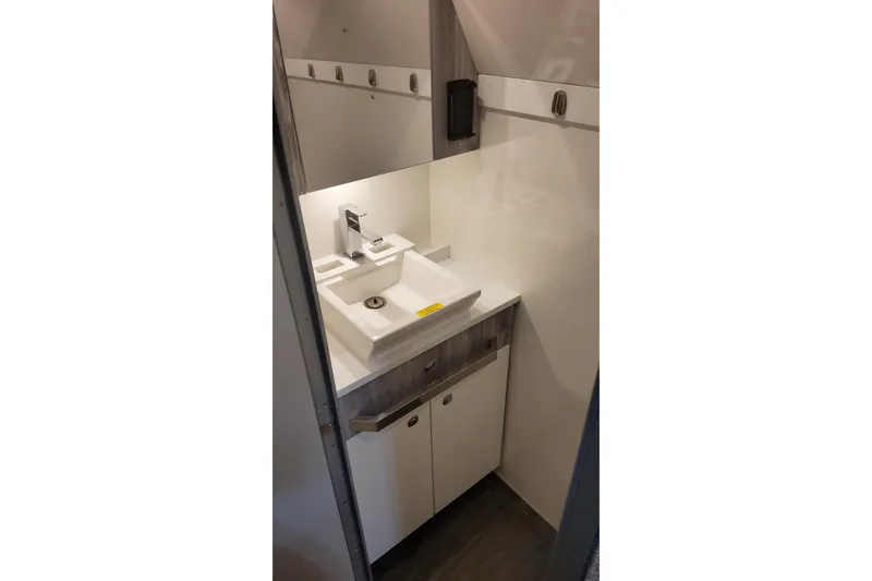 Slide: The Image of 2024 Formula 387 Center Console Fish boat bathroom with modern sink and cabinetry. - 60