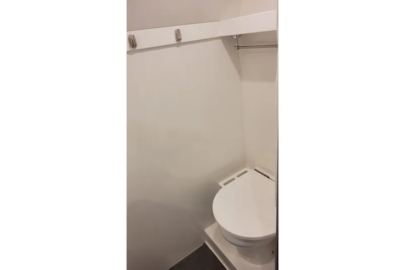 Slide: The Image of 2024 Formula 387 Center Console Fish boat interior bathroom with toilet. - 61