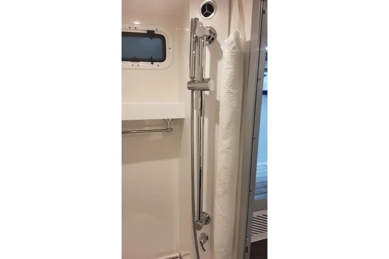 Slide: The Image of 2024 Formula 387 Center Console Fish boat shower area with chrome fixtures and window. - 62