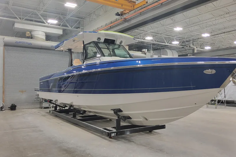 Slide: The Image of 2024 Formula 387 Center Console Fish boat in a warehouse setting. - 8