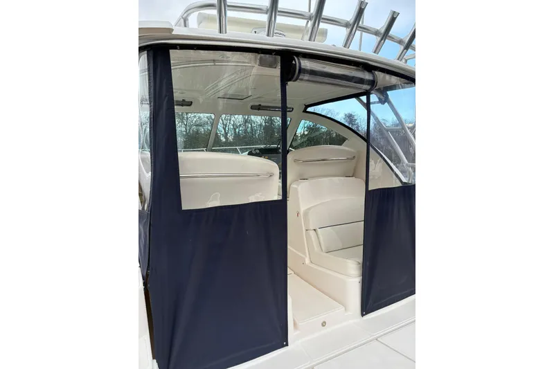 Slide: The Image of 2008 Tiara Yachts 3000 Open interior with navy blue canvas enclosure. - 16