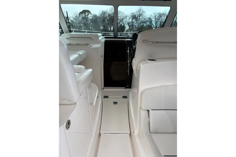 Slide: The Image of 2008 Tiara Yachts 3000 Open interior with white seating and helm view. - 19