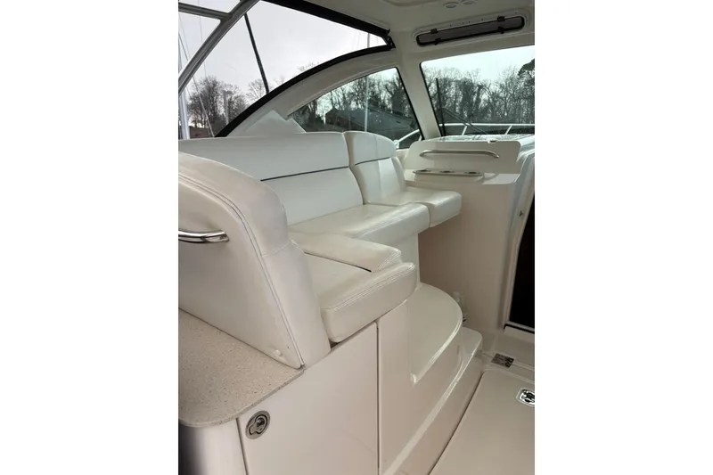 Slide: The Image of 2008 Tiara Yachts 3000 Open interior with white seating and sleek design. - 21