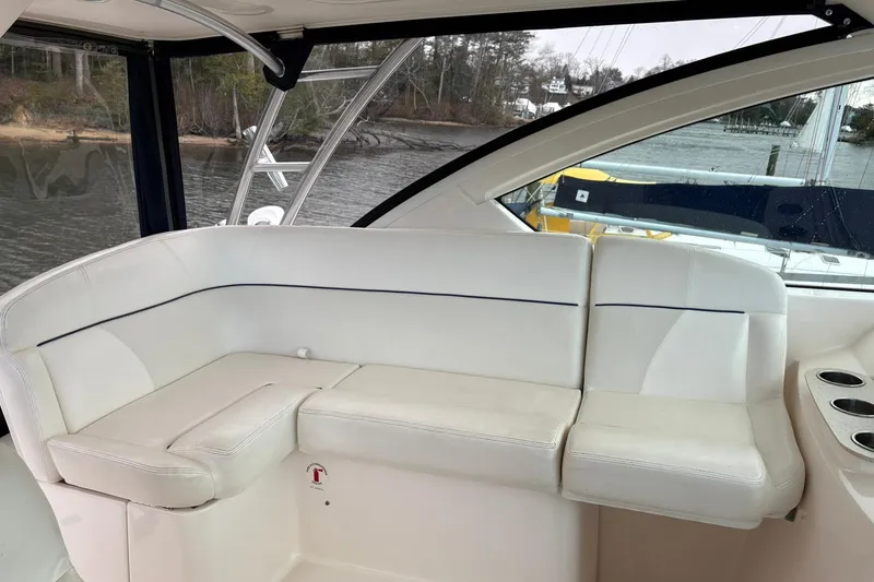Slide: The Image of 2008 Tiara Yachts 3000 Open interior with white seating and cup holders. - 25