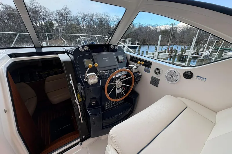 Slide: The Image of 2008 Tiara Yachts 3000 Open helm with wood steering wheel and navigation equipment. - 26