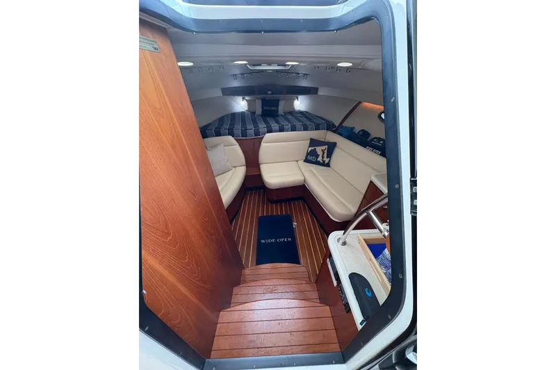 Slide: The Image of Interior of 2008 Tiara Yachts 3000 Open, featuring cozy seating and wooden flooring. - 28