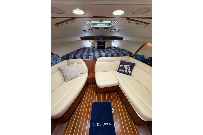 Slide: The Image of Interior of 2008 Tiara Yachts 3000 Open, featuring cozy seating and elegant wood flooring. - 29