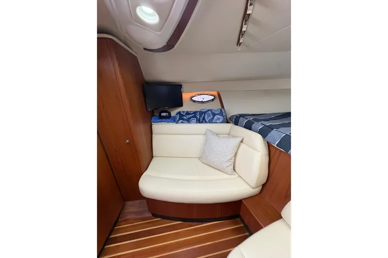 Slide: The Image of 2008 Tiara Yachts 3000 Open cabin interior with seating and wood accents. - 36