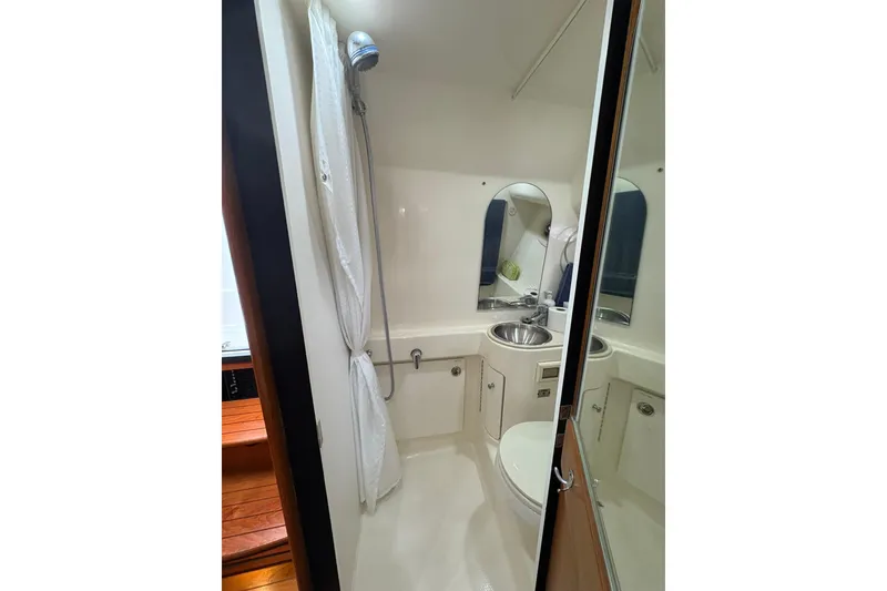 Slide: The Image of Compact bathroom in 2008 Tiara Yachts 3000 Open, featuring shower, sink, and toilet. - 38