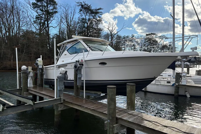 Slide: The Image of 2008 Tiara Yachts 3000 Open docked at a marina with trees in the background. - 4