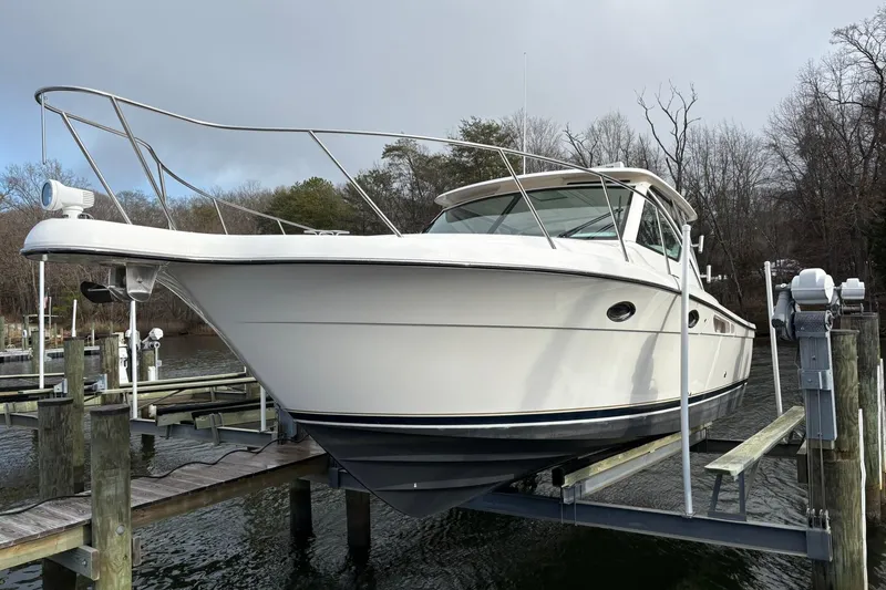 Slide: The Image of 2008 Tiara Yachts 3000 Open on lift at marina dock. - 40