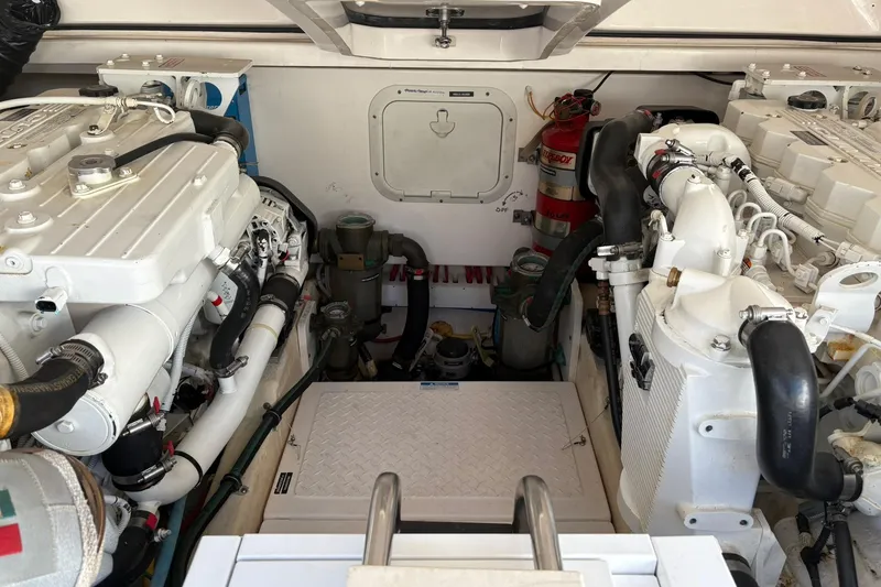 Slide: The Image of Engine room of a 2008 Tiara Yachts 3000 Open, showcasing dual engines and equipment. - 49
