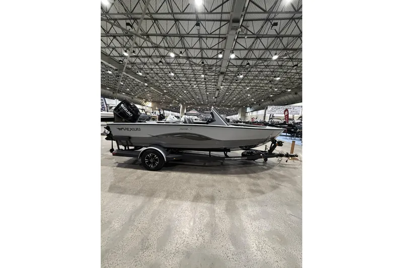 The Image of 2026 Vexus ADX 190 boat on display in a large indoor showroom. - 1