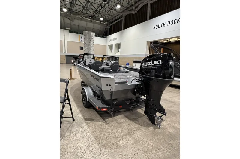 Slide: The Image of 2026 Vexus ADX 190 boat with Suzuki engine displayed indoors. - 3
