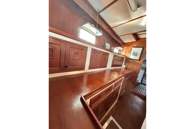 Slide: The Image of 1979 Cheoy Lee 46 LRC yacht bathroom with wooden cabinets and round mirror. - 11
