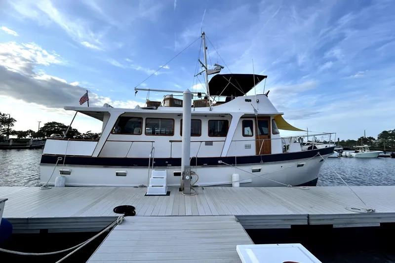 Slide: The Image of 1979 Cheoy Lee 46 LRC yacht docked at marina under blue sky. - 19