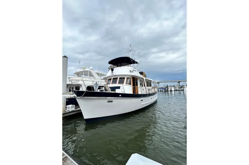 Slide: The Image of 1979 Cheoy Lee 46 LRC yacht docked, for sale, under clear blue sky. - 2