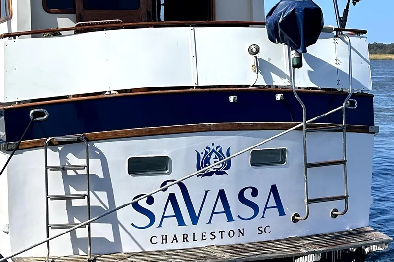 Slide: The Image of 1979 Cheoy Lee 46 LRC yacht docked, featuring "Savasa" and "Charleston SC" on the stern. - 20