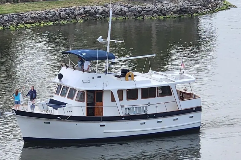 Slide: The Image of 1979 Cheoy Lee 46 LRC yacht cruising on calm waters with passengers on deck. - 21