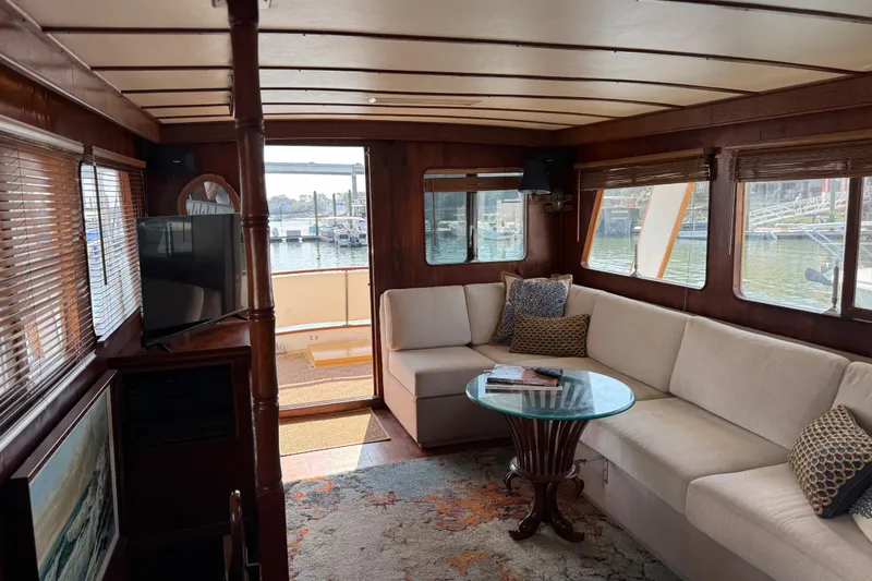 Slide: The Image of Interior of 1979 Cheoy Lee 46 LRC yacht with cozy seating and waterfront view. - 22