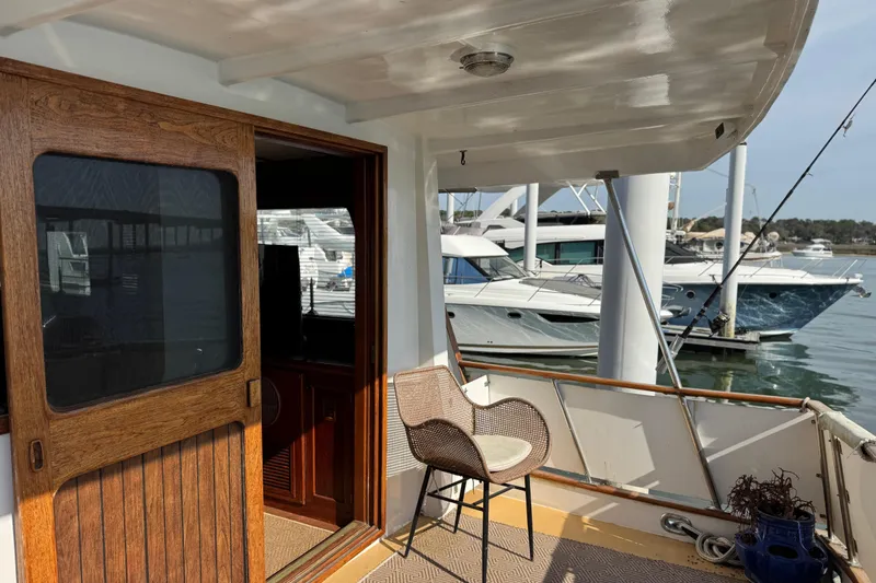 Slide: The Image of 1979 Cheoy Lee 46 LRC yacht deck with wooden door and marina view. - 24