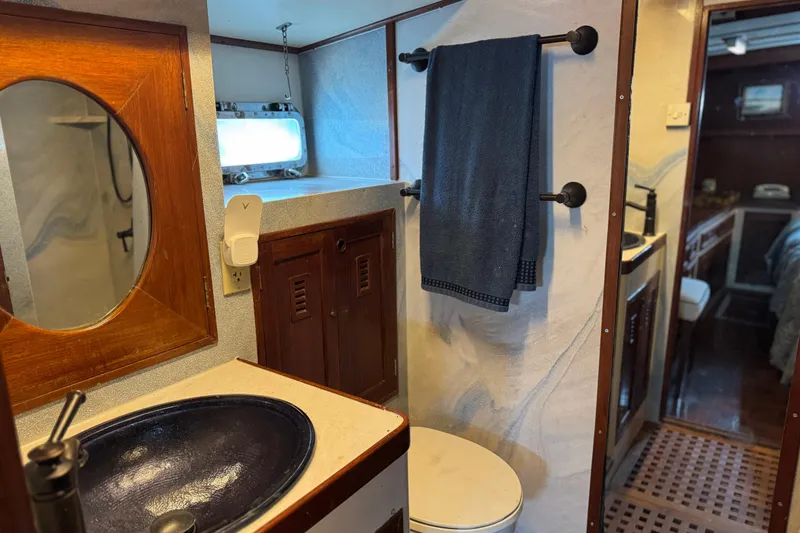 Slide: The Image of 1979 Cheoy Lee 46 LRC yacht bathroom with wooden accents and blue sink. - 27