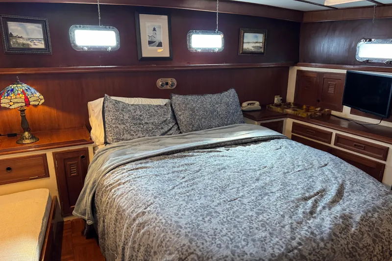 Slide: The Image of Cozy bedroom in 1979 Cheoy Lee 46 LRC yacht with elegant decor and natural light. - 29