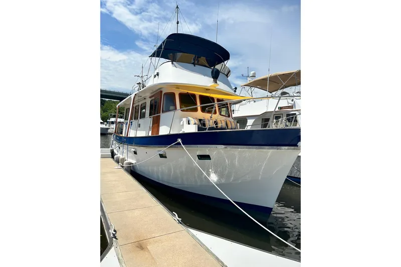 Slide: The Image of 1979 Cheoy Lee 46 LRC yacht docked at marina under clear blue sky. - 3