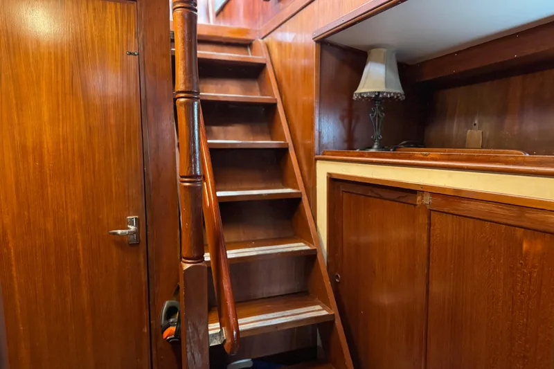Slide: The Image of Wooden interior staircase on 1979 Cheoy Lee 46 LRC yacht with lamp and cabinets. - 31