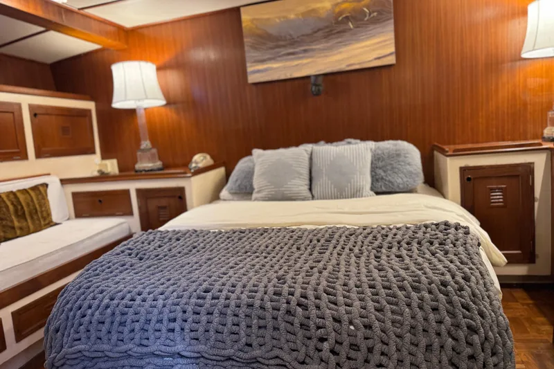 Slide: The Image of Cozy cabin interior of 1979 Cheoy Lee 46 LRC yacht with plush bedding and warm lighting. - 32