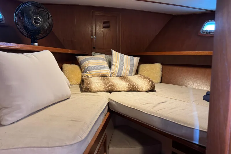 Slide: The Image of Cozy cabin interior of 1979 Cheoy Lee 46 LRC yacht with cushions and fan. - 36