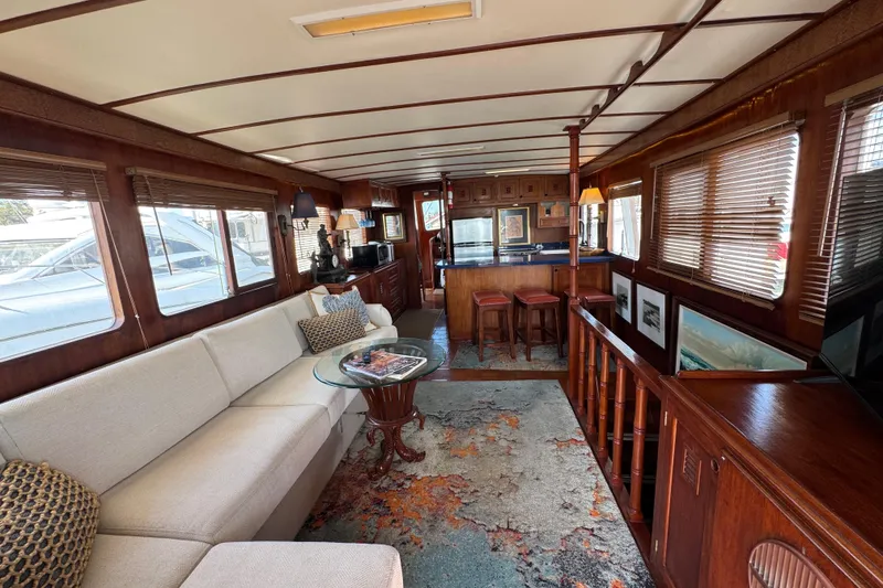 Slide: The Image of Luxurious 1979 Cheoy Lee 46 LRC yacht interior with elegant wood finishes and cozy seating. - 39