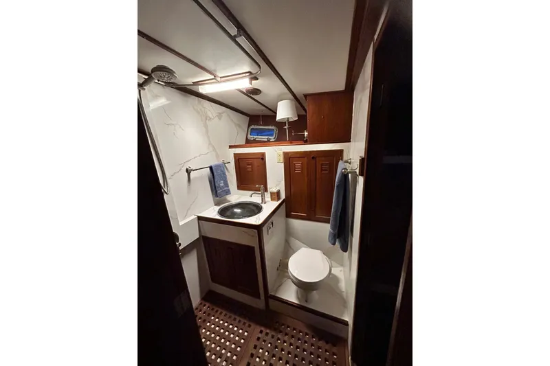 Slide: The Image of 1979 Cheoy Lee 46 LRC yacht docked in a marina, surrounded by other boats. - 4