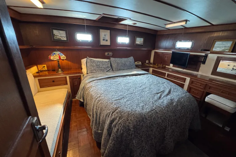 Slide: The Image of Cozy 1979 Cheoy Lee 46 LRC yacht bedroom with wood paneling and nautical decor. - 40