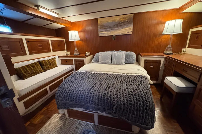 Slide: The Image of Cozy bedroom interior of 1979 Cheoy Lee 46 LRC yacht with wood paneling and soft lighting. - 41