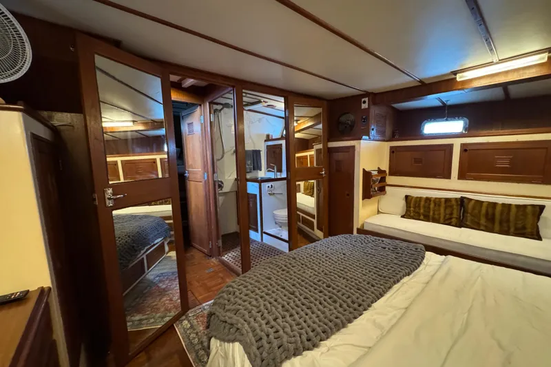 Slide: The Image of Interior of 1979 Cheoy Lee 46 LRC yacht, featuring cozy bedroom and wooden decor. - 42