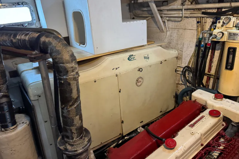 Slide: The Image of Engine room of a 1979 Cheoy Lee 46 LRC yacht, featuring machinery and piping. - 44