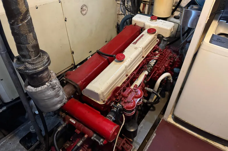 Slide: The Image of Engine room of a 1979 Cheoy Lee 46 LRC yacht, featuring a red and white engine. - 45