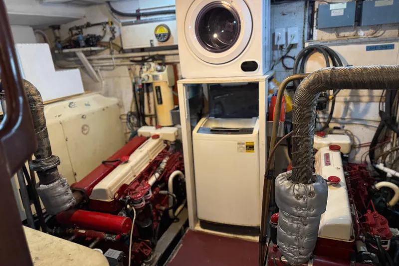 Slide: The Image of Engine room of a 1979 Cheoy Lee 46 LRC yacht with washer and dryer. - 48
