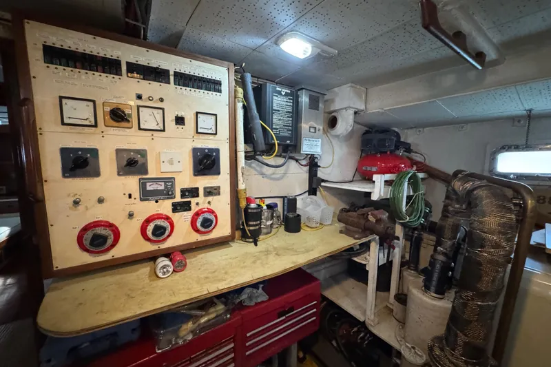 Slide: The Image of Engine room of a 1979 Cheoy Lee 46 LRC with control panel and equipment. - 50